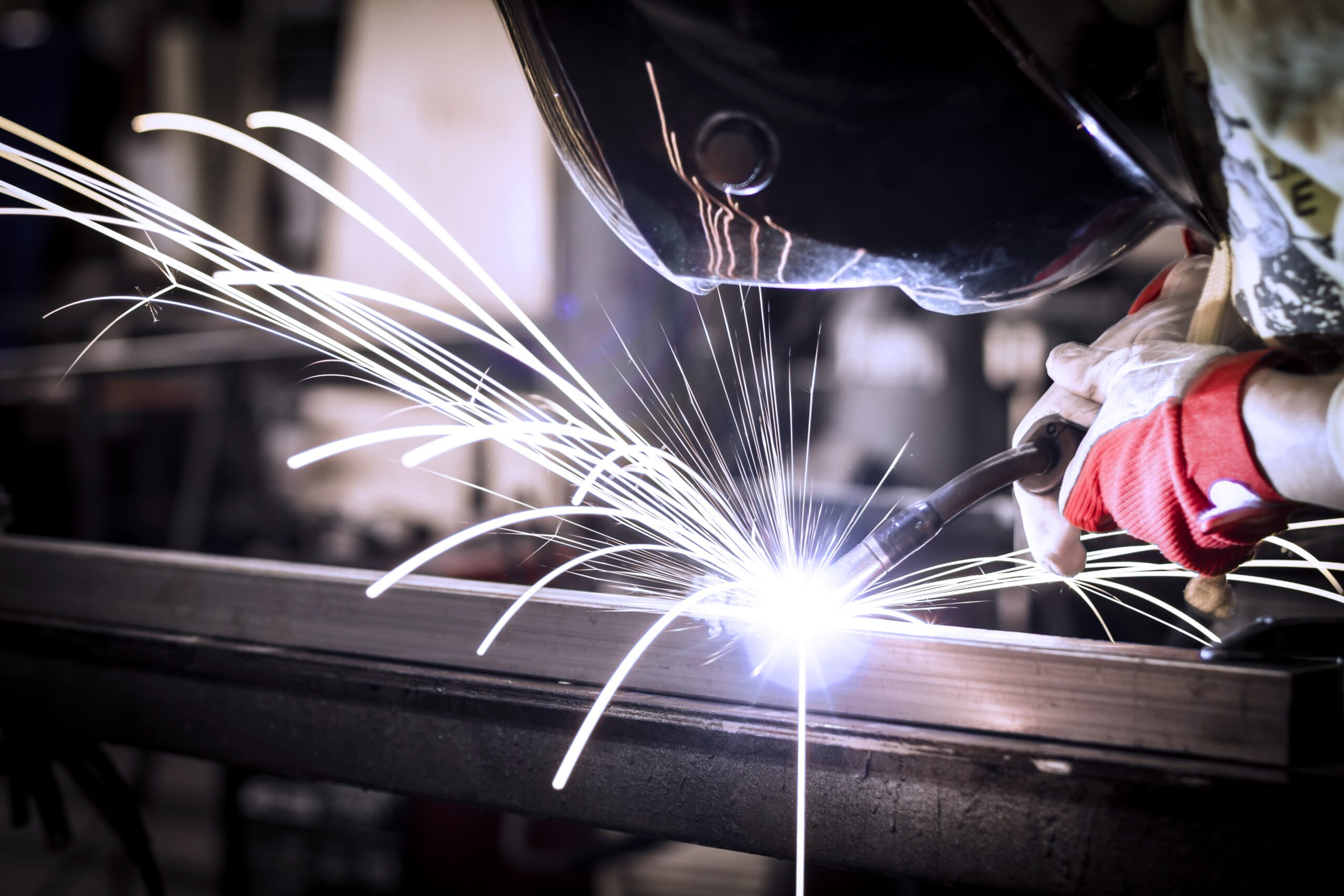Worker welding steel.